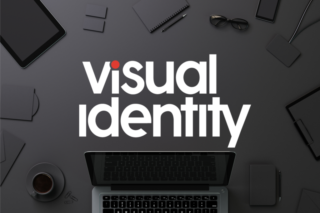 Visual Identity Logo on a desk with a laptop and other items.
